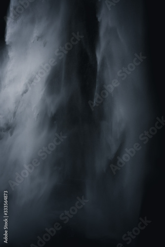 Closeup Image of Waterfall in a dark black background to isolate the water falling down
