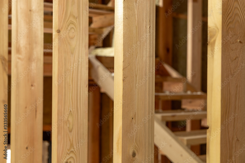 The structure of the new frame house. Close-up of wooden structures. Selected focus The structure of the new frame house. Close-up of wooden structures. Selected focus