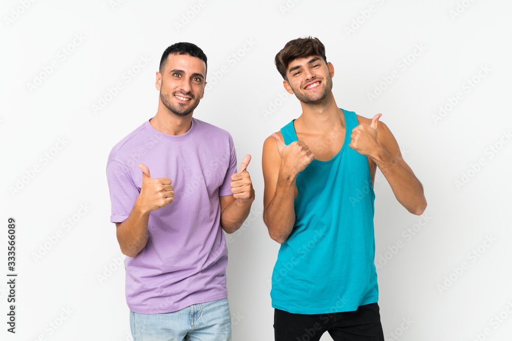Two men over isolated background giving a thumbs up gesture with both hands and smiling Two men over isolated background giving a thumbs up gesture with both hands and smiling