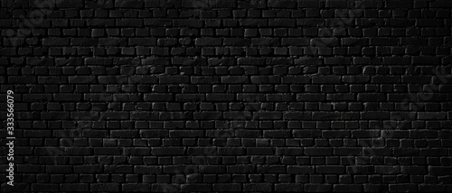 Texture of a black brick wall as a background or wallpaper