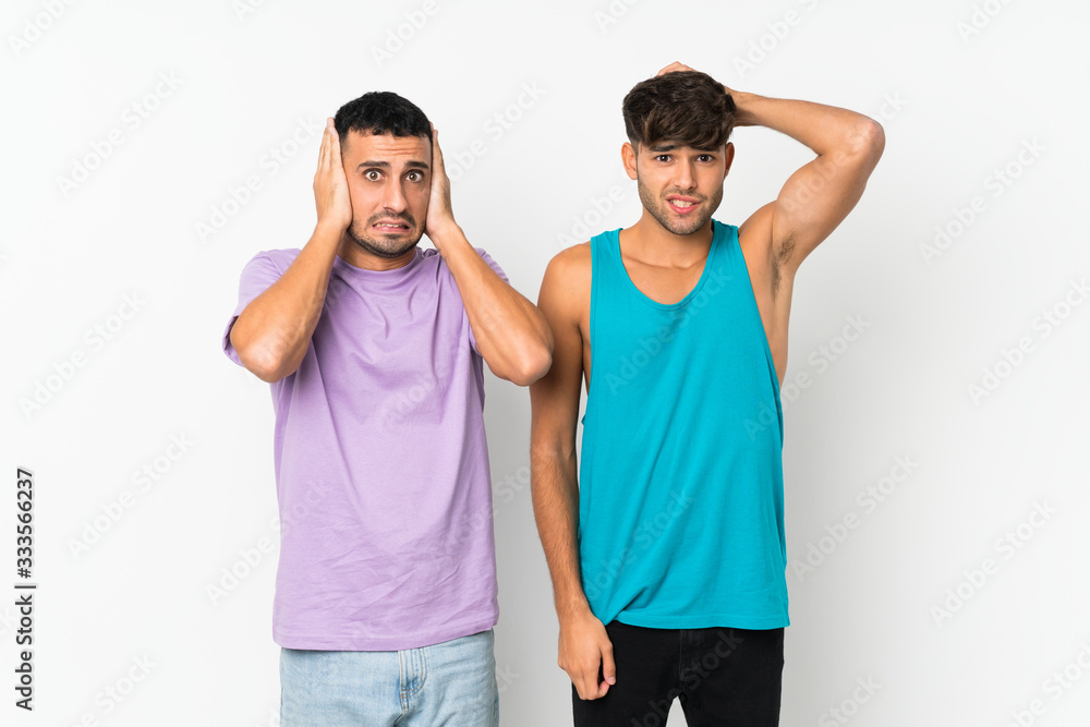 Two men over isolated background takes hands on head because has migraine Two men over isolated background takes hands on head because has migraine