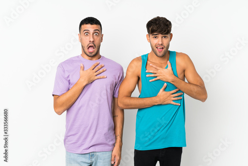 Two men over isolated background surprised and shocked while looking right