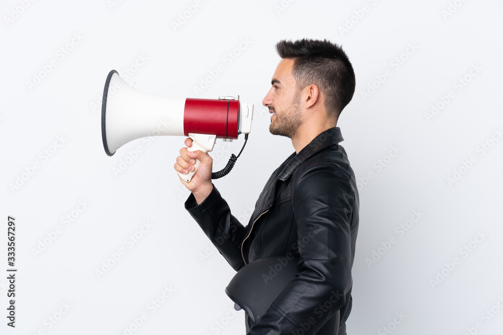 Man with a motorcycle helmet shouting through a megaphone Man with a motorcycle helmet shouting through a megaphone