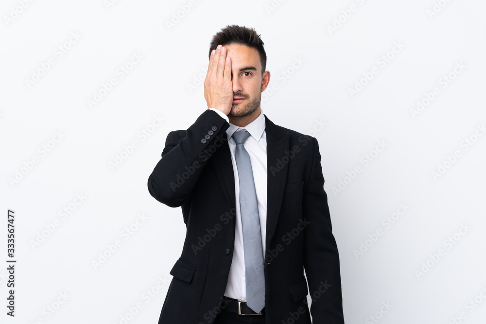 Young business man over isolated background covering a eye by hand Young business man over isolated background covering a eye by hand