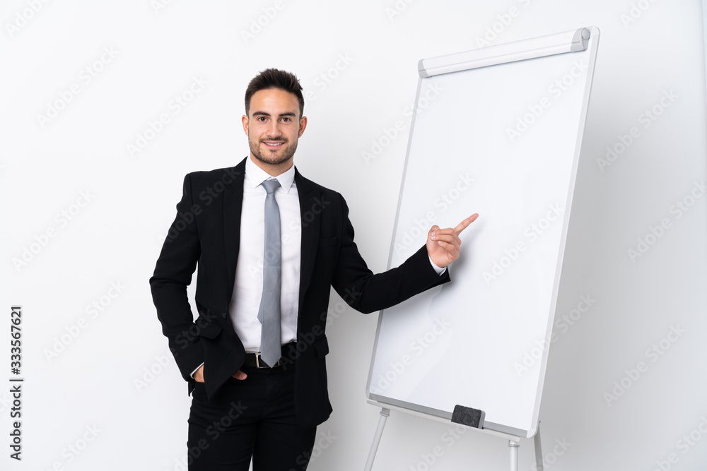 Young man giving a presentation on white board and pointing it Young man giving a presentation on white board and pointing it