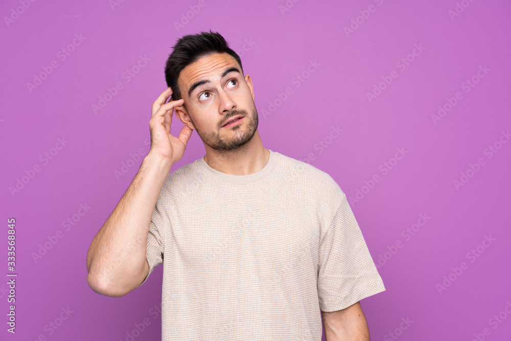Young handsome man over isolated purple background thinking an idea Young handsome man over isolated purple background thinking an idea