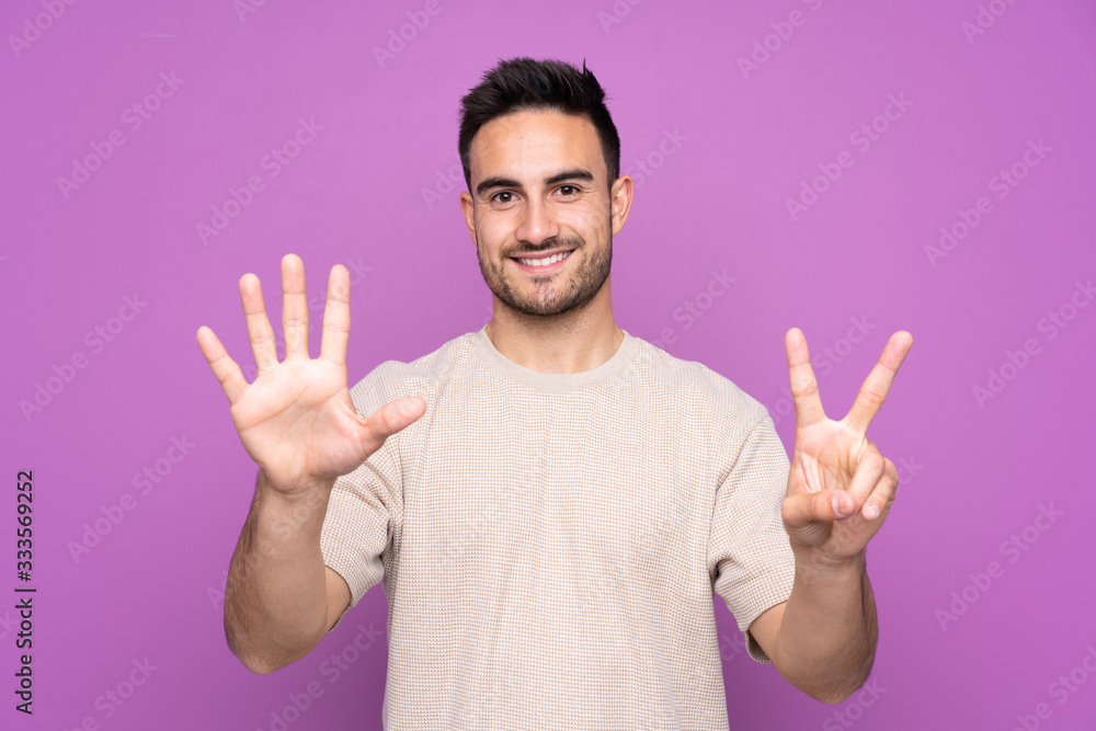 Young handsome man over isolated purple background counting seven with fingers Young handsome man over isolated purple background counting seven with fingers