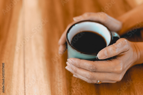 Cup of brewed black coffe on the wooden table