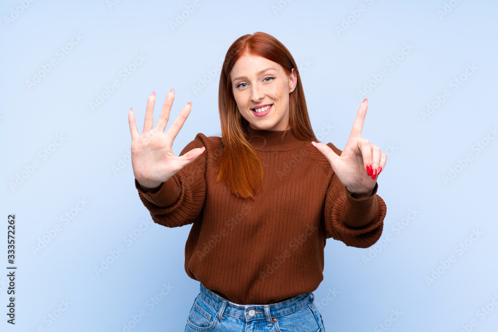 Young redhead woman over isolated blue background counting seven with fingers Young redhead woman over isolated blue background counting seven with fingers