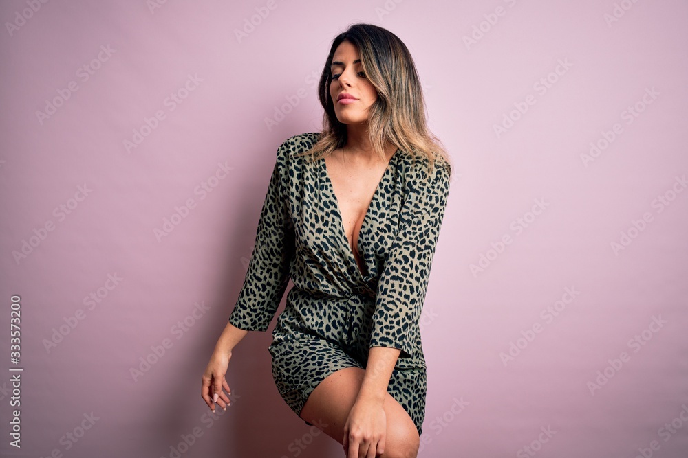 Young beautiful woman wearing fashion urban clothes, model wearing casual street style standing over pink background Young beautiful woman wearing fashion urban clothes, model wearing casual street style standing over pink background