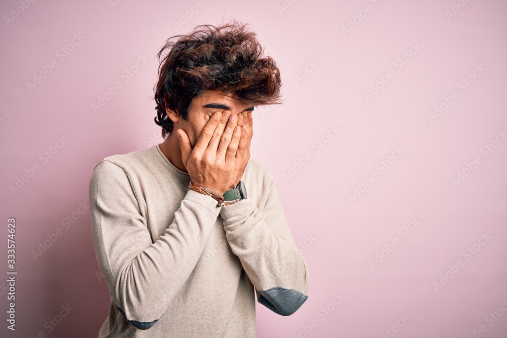 Young handsome man wearing casual t-shirt standing over isolated pink background rubbing eyes for fatigue and headache, sleepy and tired expression. Vision problem Young handsome man wearing casual t-shirt standing over isolated pink background rubbing eyes for fatigue and headache, sleepy and tired expression. Vision problem