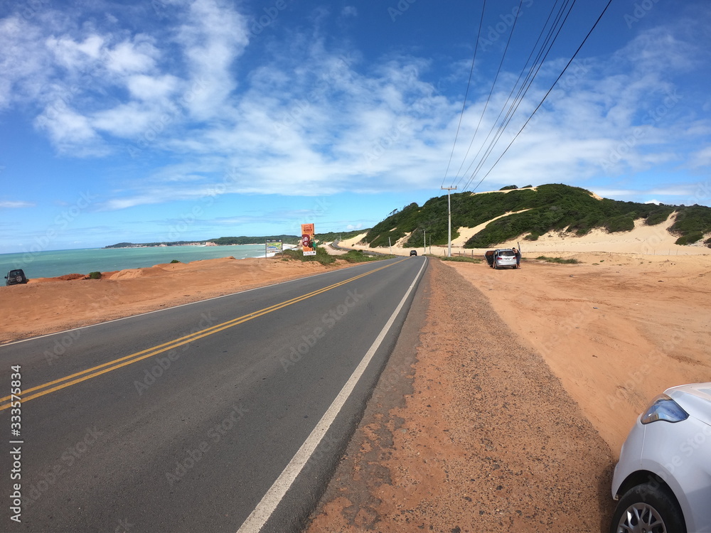 Fototapeta premium Desert and ocean landscape with winding road