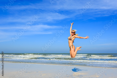  woman jumping on the beach