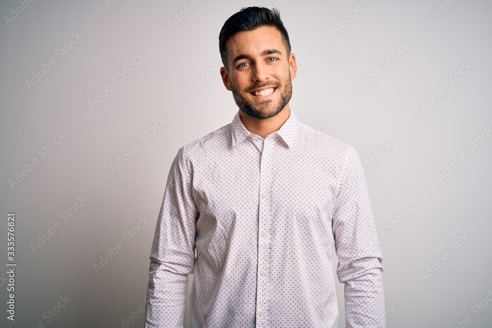 Young handsome man wearing elegant shirt standing over isolated white background with a happy and cool smile on face. Lucky person. Young handsome man wearing elegant shirt standing over isolated white background with a happy and cool smile on face. Lucky person.