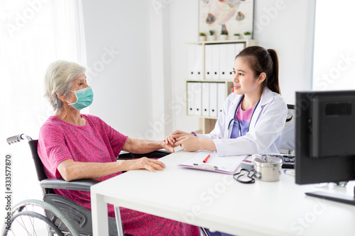 asian female doctor holding hand of old patient in mental health clinic  patient have a problem health in hospital  hand in hand  elderly healthcare promotion