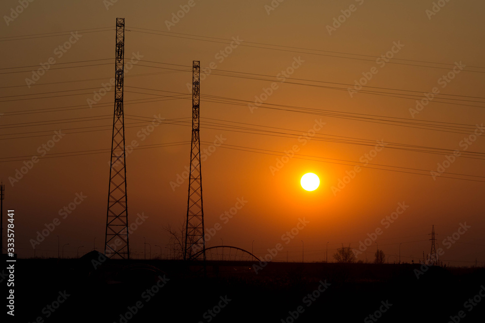 Fototapeta premium Sunset on the background of the road and antennas. Beautiful landscape. Background.