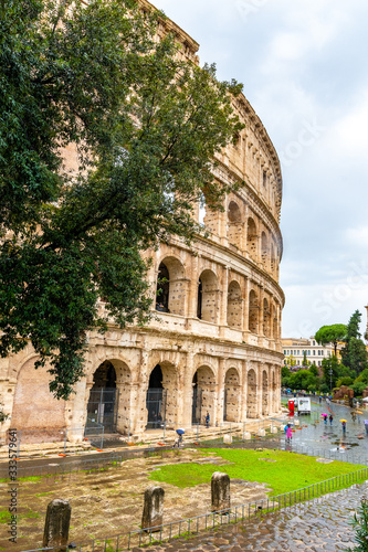 Rome, Italy. Section of the Ancient Roman Colosseum, a popular European city amphitheater landmark and tourist attraction. Beautiful historic iconic vintage architecture ruins on rainy/ overcast day.