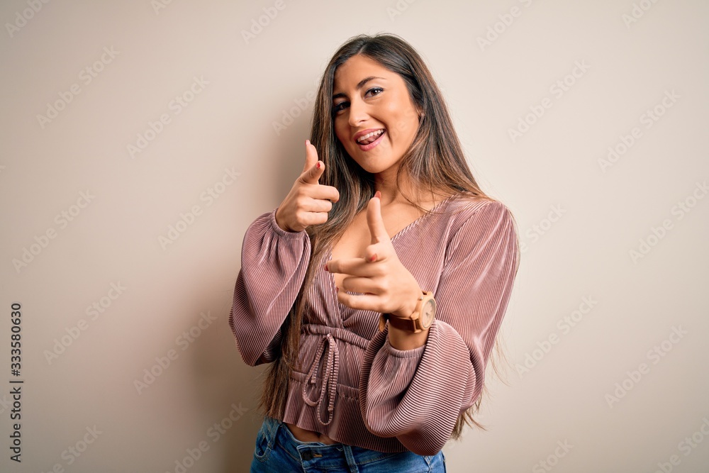 Young beautiful brunette elegant woman with long hair standing over isolated background pointing fingers to camera with happy and funny face. Good energy and vibes. Young beautiful brunette elegant woman with long hair standing over isolated background pointing fingers to camera with happy and funny face. Good energy and vibes.