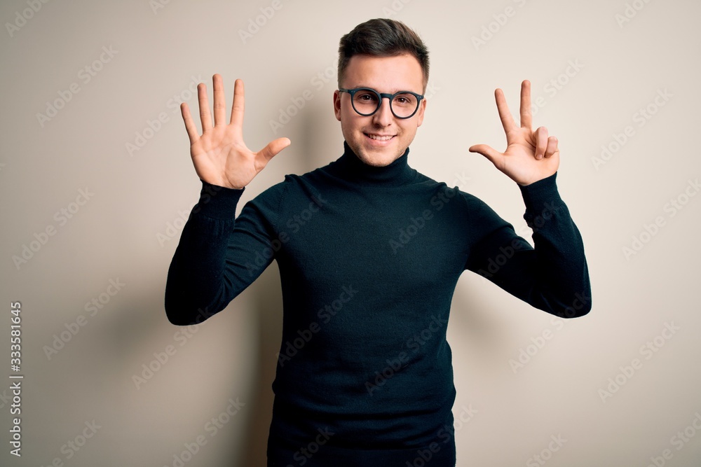 Young handsome caucasian man wearing glasses and casual sweater over isolated background showing and pointing up with fingers number eight while smiling confident and happy. Young handsome caucasian man wearing glasses and casual sweater over isolated background showing and pointing up with fingers number eight while smiling confident and happy.