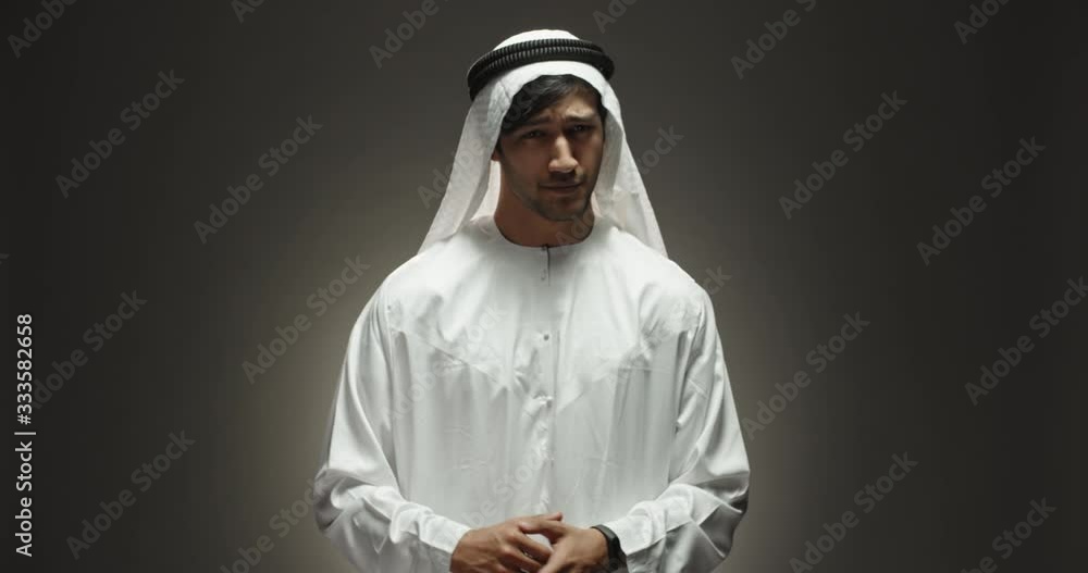 Bearded angry arab man looking at camera and crossing his arms in Bearded angry arab man looking at camera and crossing his arms in