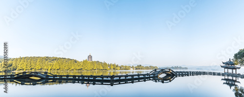 Sunny scenery of Leifeng Pagoda and Shuangtou Bridge in West Lake, Hangzhou, Zhejiang, China photo