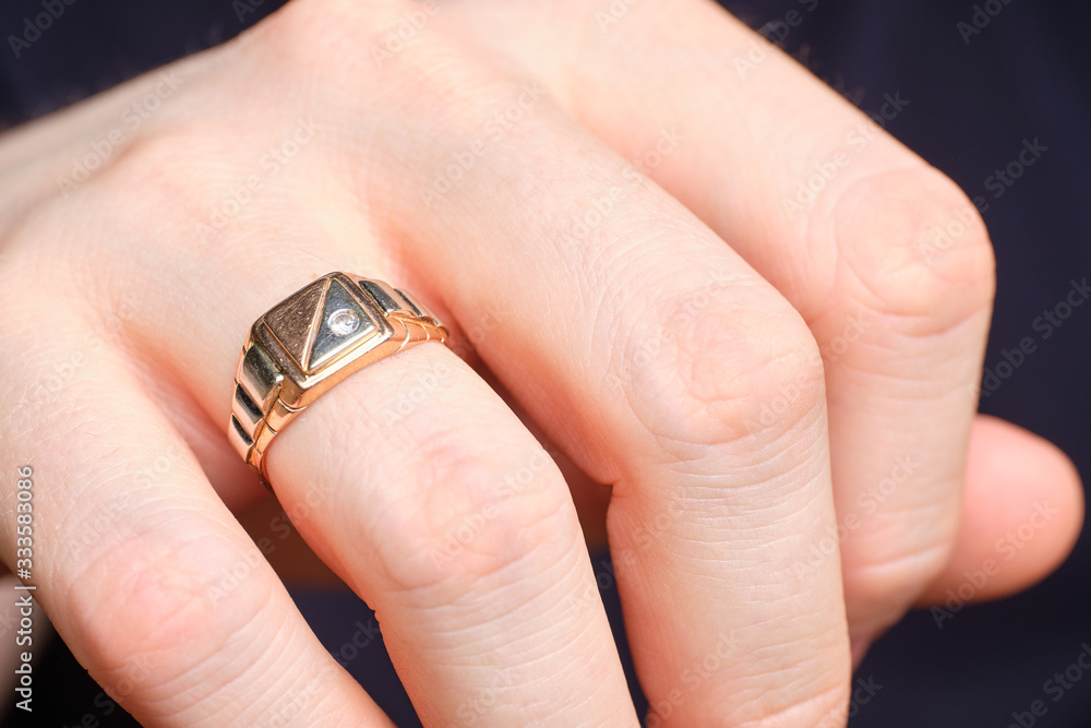 Golden ring on a man finger.