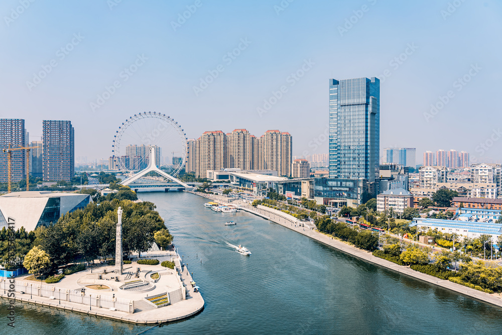 Fototapeta premium Twilight scenery of Haihe River and Ferris wheel in Tianjin, China 