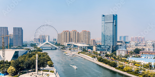 Twilight scenery of Haihe River and Ferris wheel in Tianjin, China  © Govan