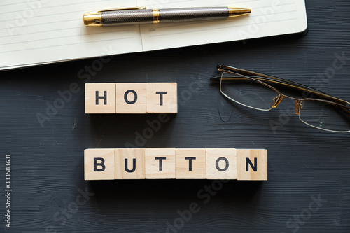 Modern business buzzword - hot button. Top view on wooden table with blocks. Top view. photo