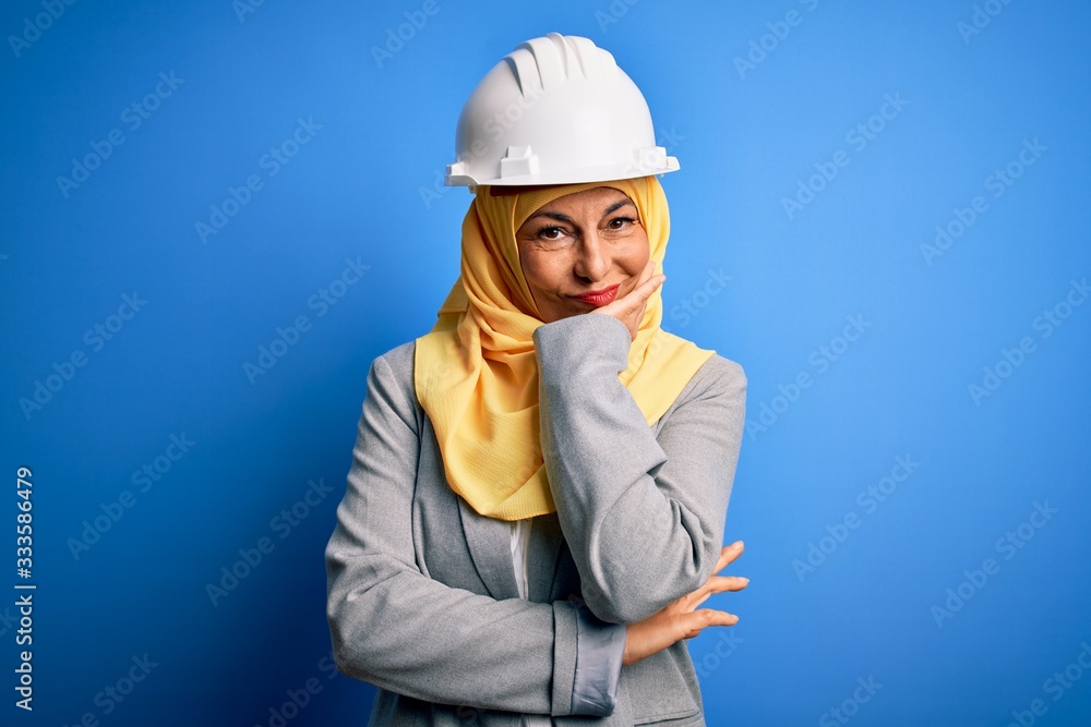Middle age brunette architect woman wearing muslim traditional hijab and security helmet thinking looking tired and bored with depression problems with crossed arms. Middle age brunette architect woman wearing muslim traditional hijab and security helmet thinking looking tired and bored with depression problems with crossed arms.