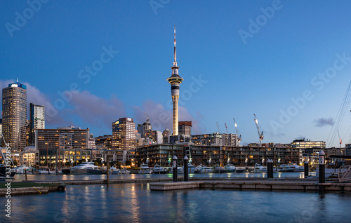 Twilight view of sky tower view from Viaduct Harbour in the central of Auckland, New Zealand. Auckland is New Zealand's largest city and the centre of the country's retail and commercial activities.