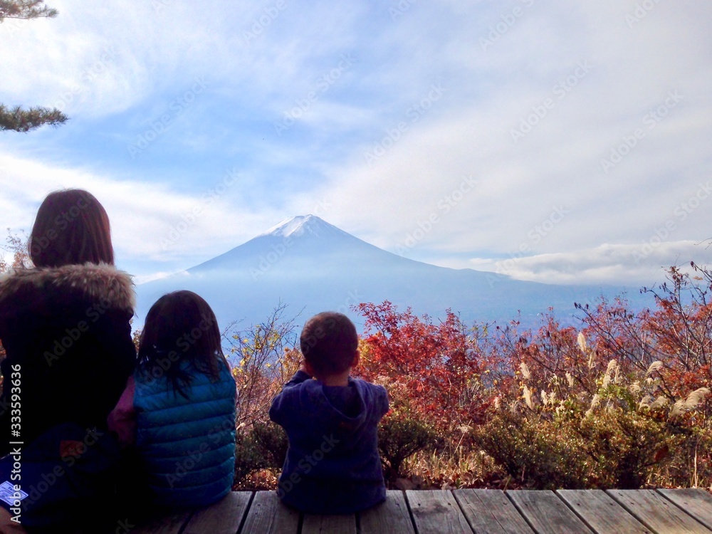 Family watching Mount Fuji and autumn leaves