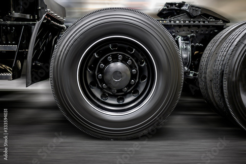 Chassis with wheels and fifth wheel coupling of a modern heavy black big rig semi truck © vit