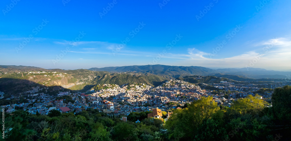 Mexico, Scenic panoramic view of Taxco historic center with colonial houses on the hills and famous Church of Santa Prisca de Taxco