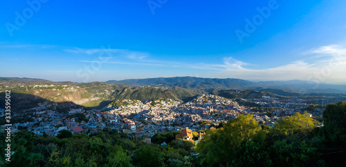 Mexico, Scenic panoramic view of Taxco historic center with colonial houses on the hills and famous Church of Santa Prisca de Taxco