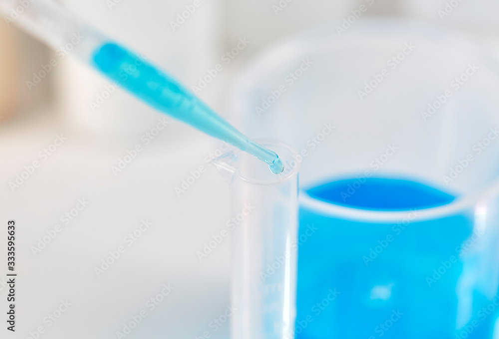 Blue Liquid dropping into a Test Tube Blue Liquid dropping into a Test Tube