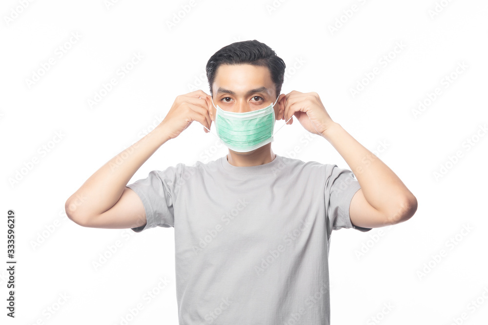 Young Asian Man wearing hygienic mask to prevent infection, 2019-nCoV or coronavirus. Airborne respiratory illness such as pm 2.5 fighting and flu. Studio shot isolated on white background. Young Asian Man wearing hygienic mask to prevent infection, 2019-nCoV or coronavirus. Airborne respiratory illness such as pm 2.5 fighting and flu. Studio shot isolated on white background.