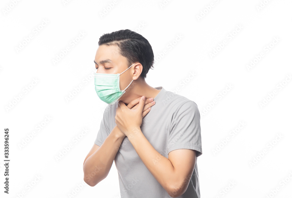 Young Asian Man in hygienic mask suffering sore throat, 2019-nCoV or coronavirus. Airborne respiratory illness such as pm 2.5 fighting and flu. Studio shot isolated on white background. Young Asian Man in hygienic mask suffering sore throat, 2019-nCoV or coronavirus. Airborne respiratory illness such as pm 2.5 fighting and flu. Studio shot isolated on white background.