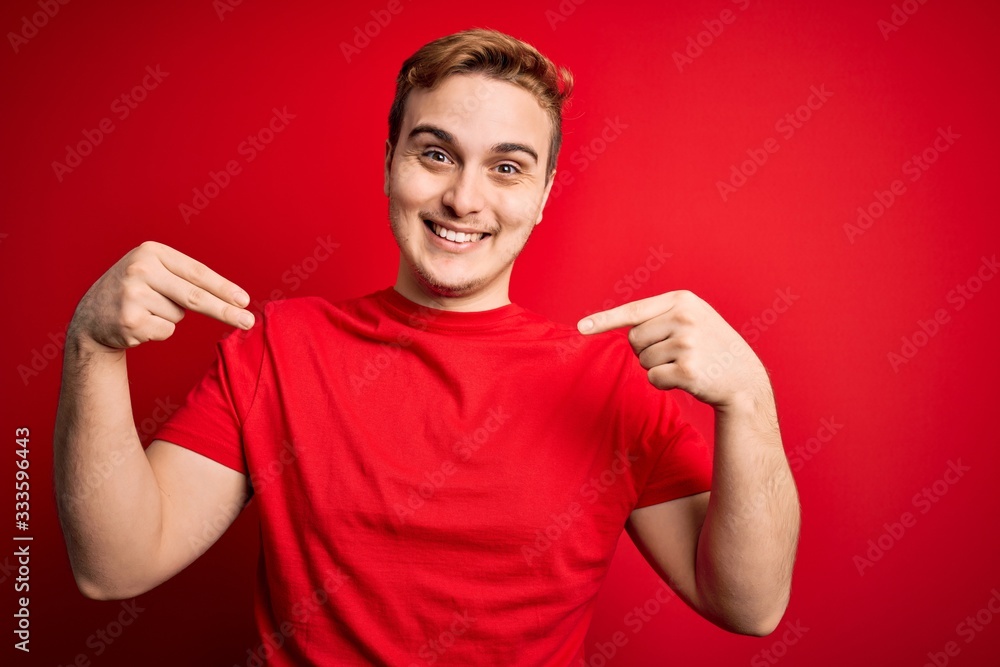 Young handsome redhead man wearing casual t-shirt over isolated red background looking confident with smile on face, pointing oneself with fingers proud and happy. Young handsome redhead man wearing casual t-shirt over isolated red background looking confident with smile on face, pointing oneself with fingers proud and happy.