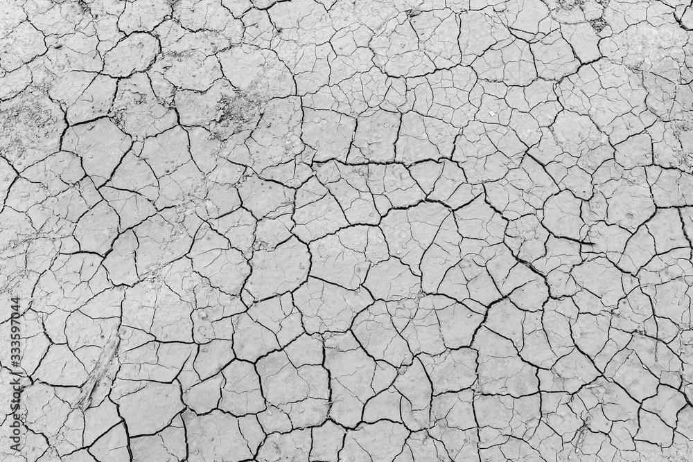 Gray dry soil ground cracks background texture in drought, Top view Gray dry soil ground cracks background texture in drought, Top view
