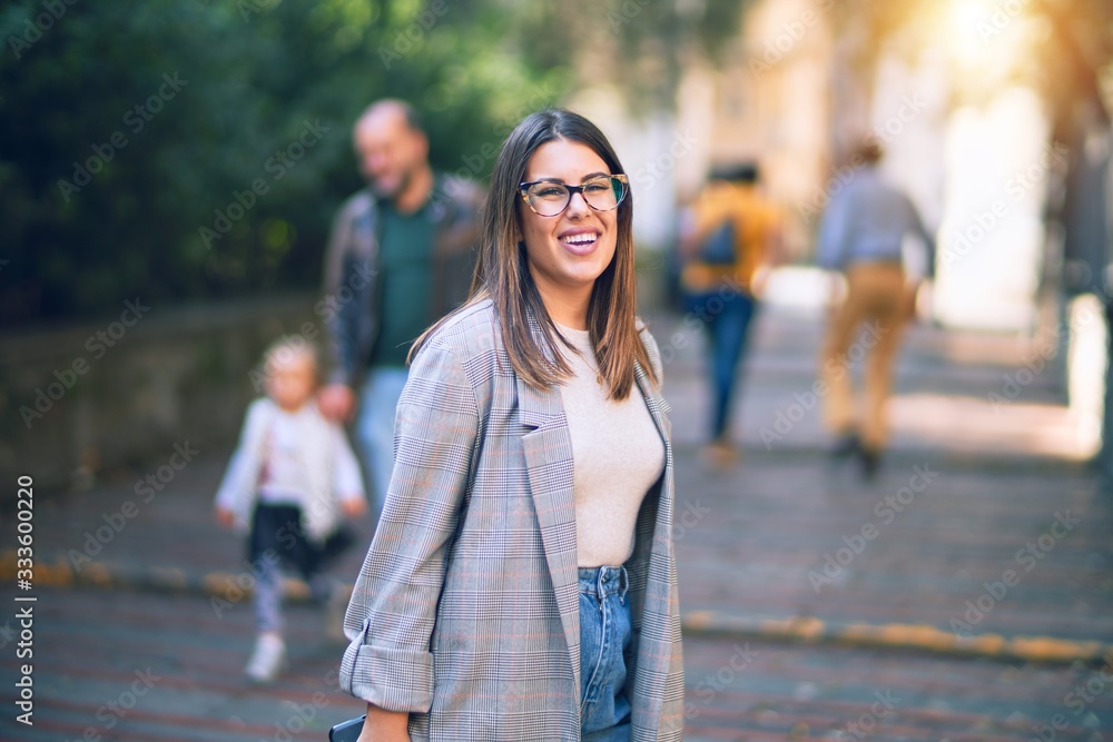 Young beautiful woman smiling happy and confident. Standing with smile on face at the town street Young beautiful woman smiling happy and confident. Standing with smile on face at the town street
