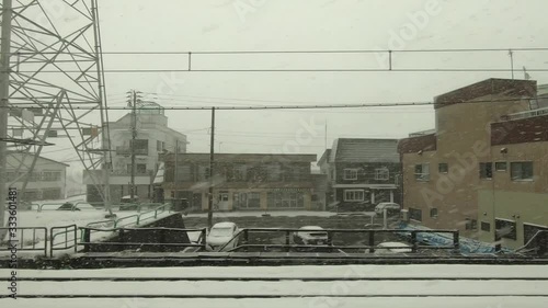 Winter cityscape. Japan Railway train window