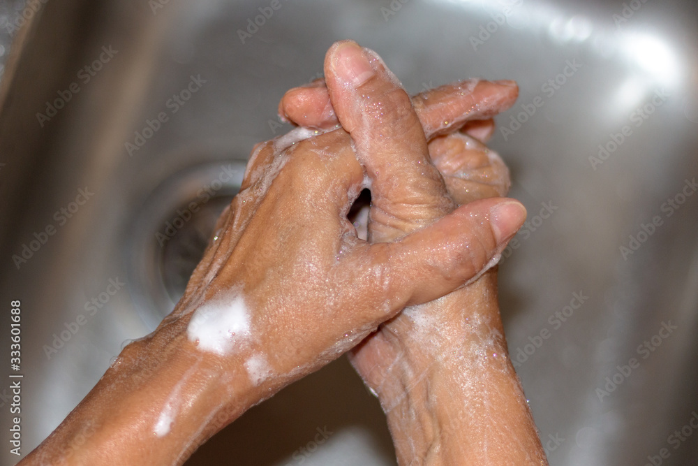 Fototapeta premium A lady is washing her hands to prevent 2019-nCoV or Coronavirus