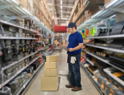 Male staff and parcel boxes checking stock and Blurred the background of the warehouse