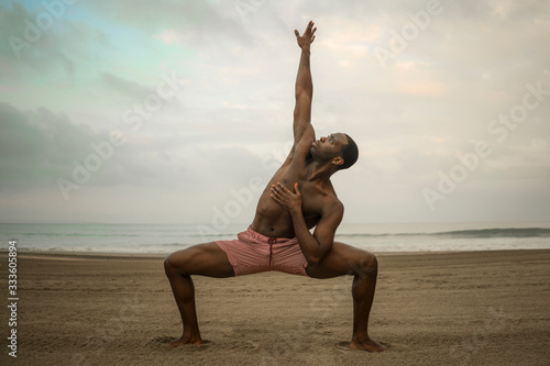 dance choreographer and dancer doing ballet beach workout - young attractive and athletic black African American man dancing outdoors doing beautiful performance