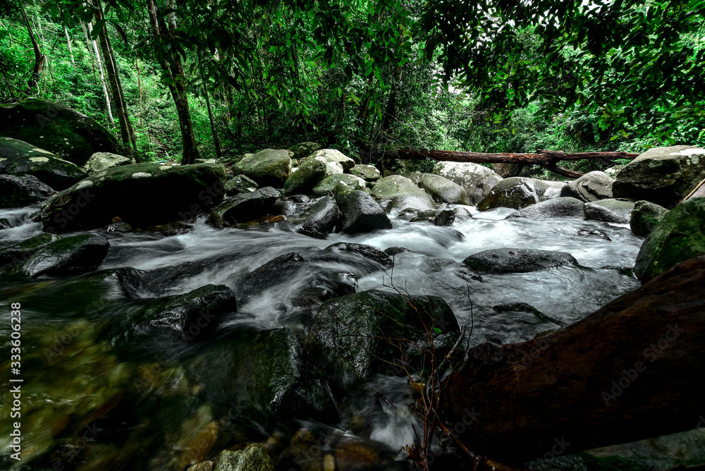 The water that flows down from the mountain through rocks in Khao Chamao Waterfall Rayong, Thailand, Stream 12 August 2018 The water that flows down from the mountain through rocks in Khao Chamao Waterfall Rayong, Thailand, Stream 12 August 2018