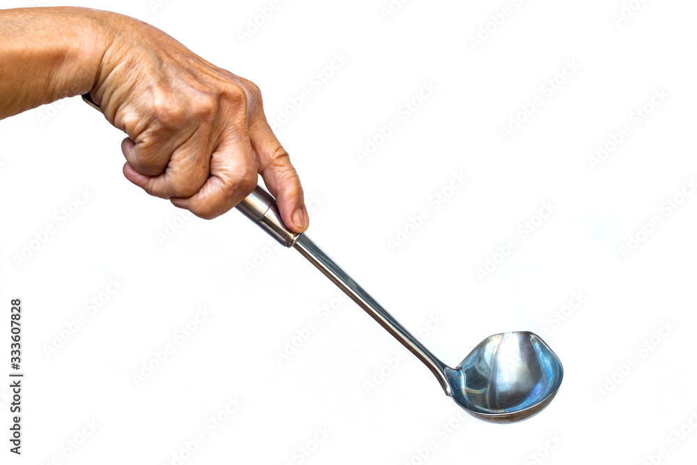 Senior woman's right hand holding Stainless on white background, Close up shot, Selective focus, Kitchen utensils concept Senior woman's right hand holding Stainless on white background, Close up shot, Selective focus, Kitchen utensils concept