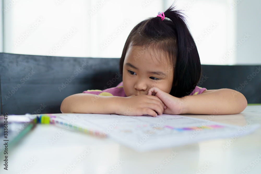 Kindergarten Asian girl doing homework at home. But homework is difficult, not fun and boring. Kindergarten Asian girl doing homework at home. But homework is difficult, not fun and boring.
