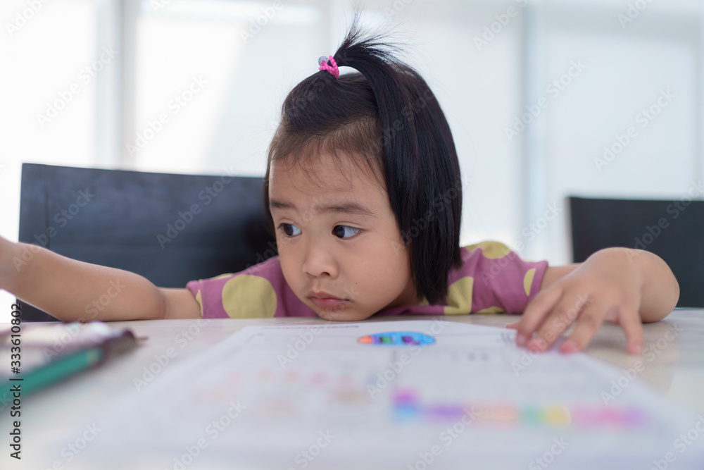 Kindergarten Asian girl doing homework at home. But homework is difficult, not fun and boring. Kindergarten Asian girl doing homework at home. But homework is difficult, not fun and boring.