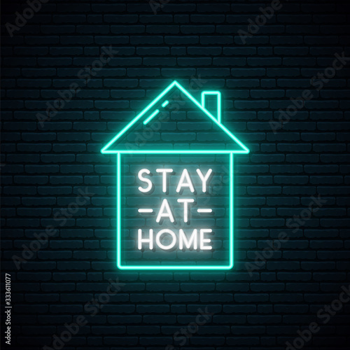 Stay at home neon signboard. Awareness social media campaign and Coronavirus prevention. Symbol of home with text Stay at home in bright neon style.